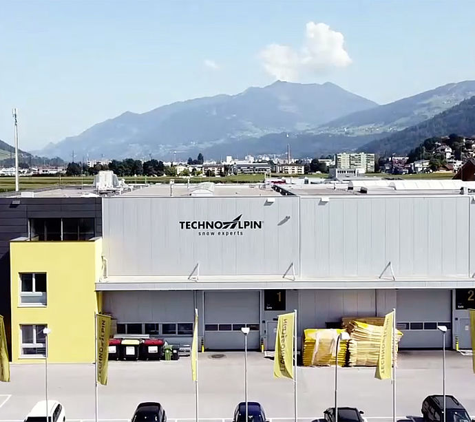 TechnoAlpin Firmengebäude mit Bergpanorama im Hintergrund