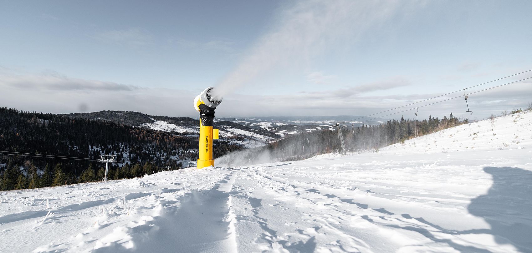 Yellow TechnoAlpin snow gun on slope in Bachledka ski resort
