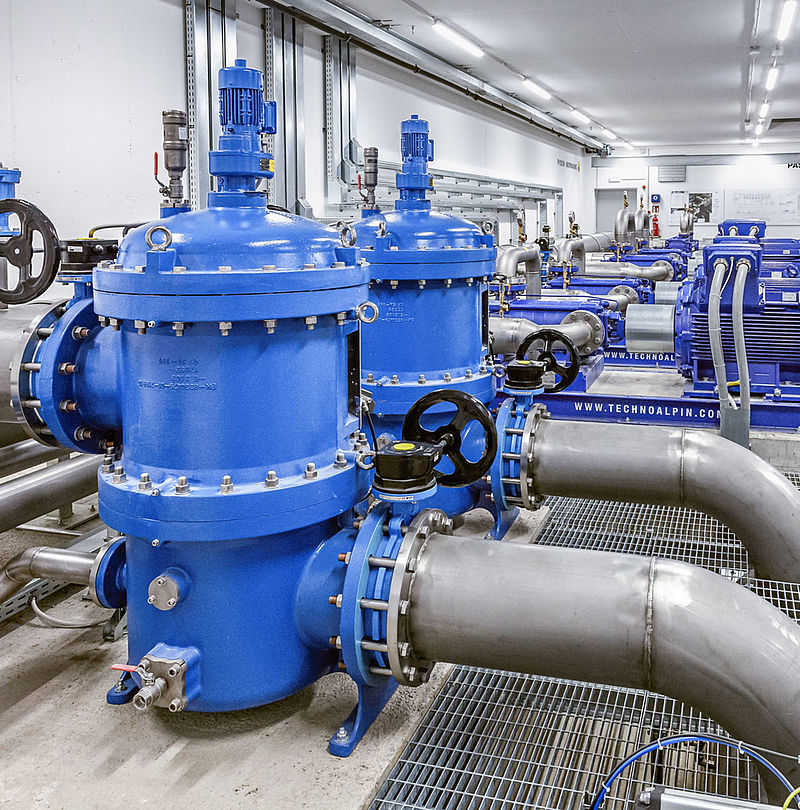 TechnoAlpin pump station with blue filters and piping for snowmaking system