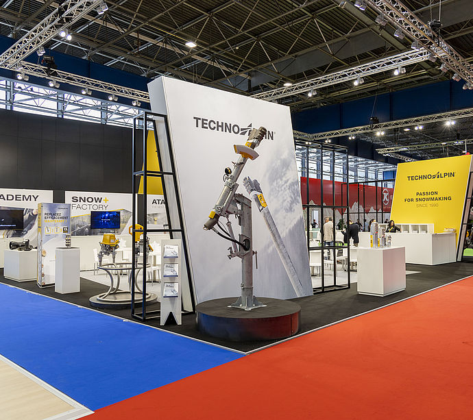 Overview of TechnoAlpin trade show stand with snow lance, Academy and Snow Factory area.