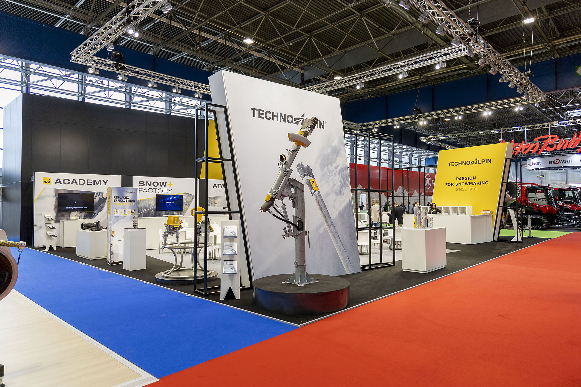 Overview of TechnoAlpin trade show stand with snow lance, Academy and Snow Factory area.