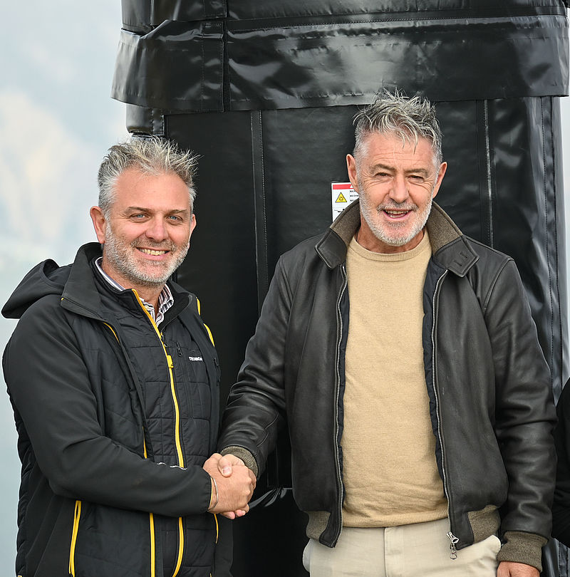 TechnoAlpin Sales Manager Omar Faustini and Mottolino CEO Ian Rocca shake hands.