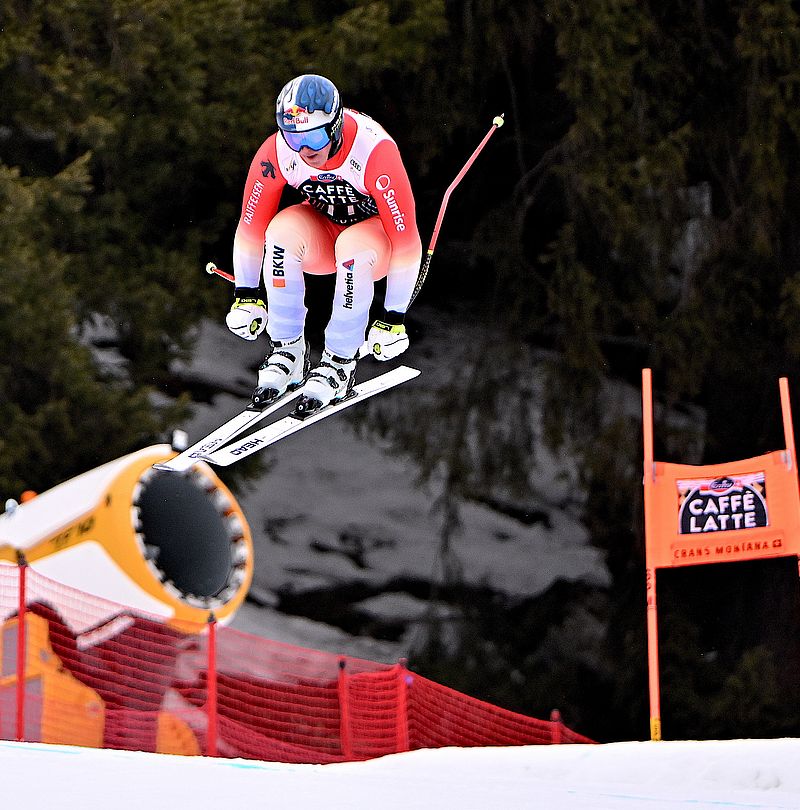 Female ski racer jumps over snow gun during World Cup downhill in Crans Montana