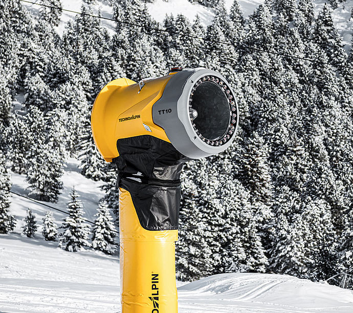 Seitenansicht der TechnoAlpin TT10 Schneekanone vor verschneitem Bergwald