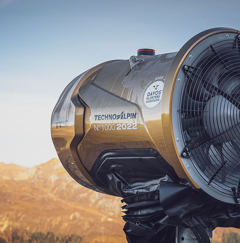 Close-up of gold TechnoAlpin TT10 No.1000 (2022) fan snow gun with Davos Klosters Mountains sticker