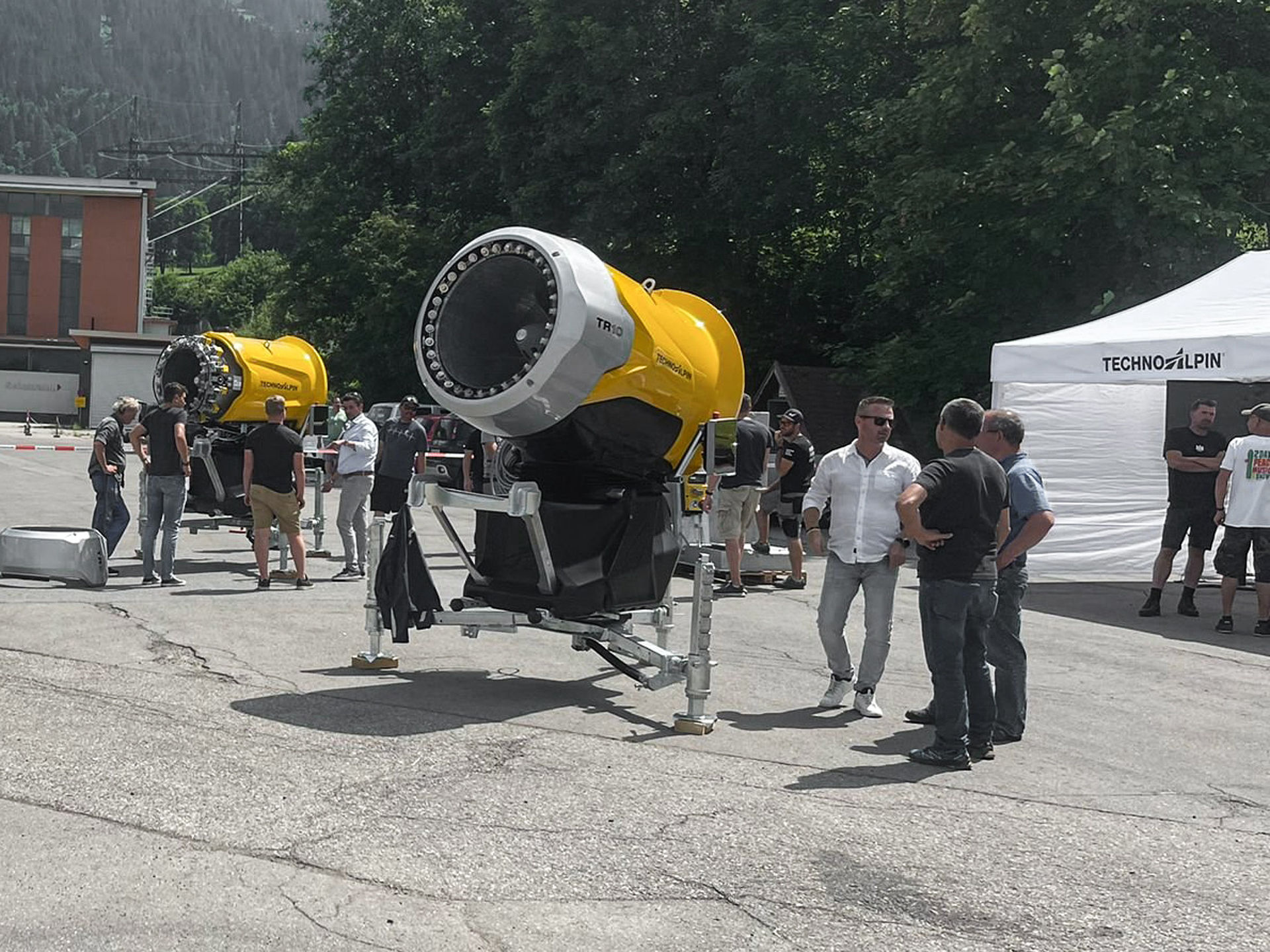 Two yellow TR10 propeller snow generators on TechnoAlpin roadshow grounds.