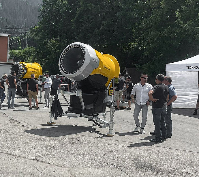 Two yellow TR10 propeller snow generators on TechnoAlpin roadshow grounds.