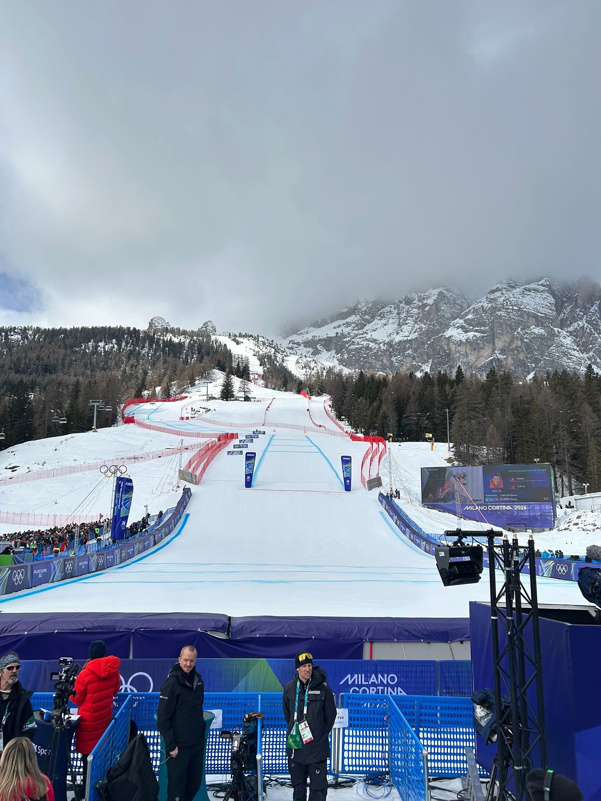 Full biathlon stadium in Anterselva with spectators and athletes in sunny mountain scenery
