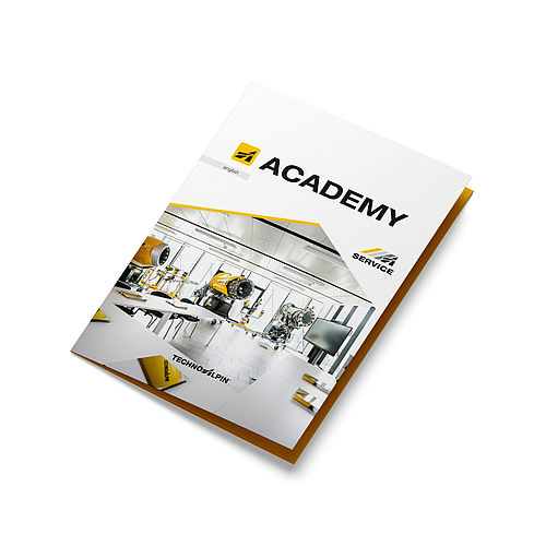 Mockup TechnoAlpin ACADEMY Service-Broschüre mit Schulungsraum und Propellermaschinen auf dem Cover