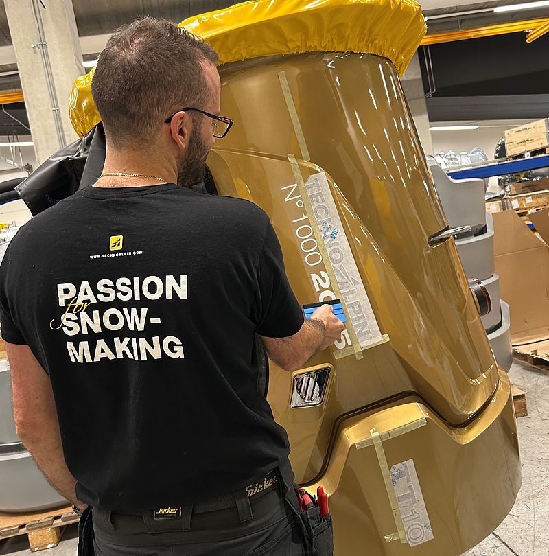 Employee decorates golden anniversary snow gun in TechnoAlpin production
